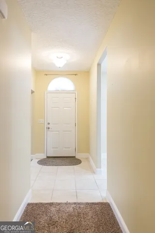 a view of room with wooden floor and cabinets