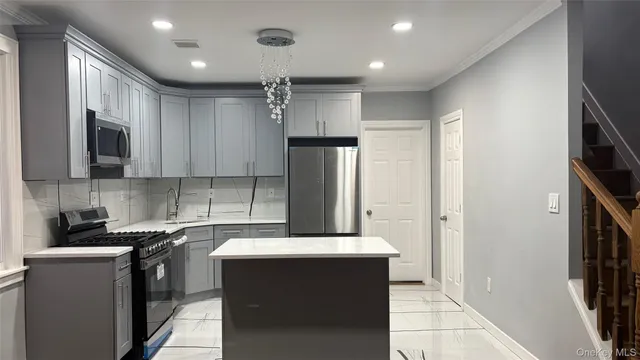 a kitchen with a sink and refrigerator