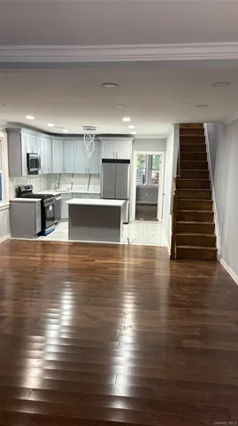 a view of kitchen with cabinets and wooden floor