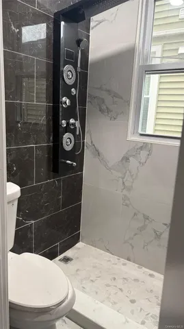 a bathroom with a toilet a sink and shower