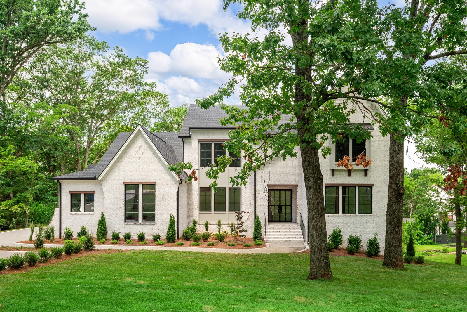 0 Bethesda-Arno Road Thompson's Station, TN 37179 - Photo 2 of 78 a front view of a house with a garden and trees