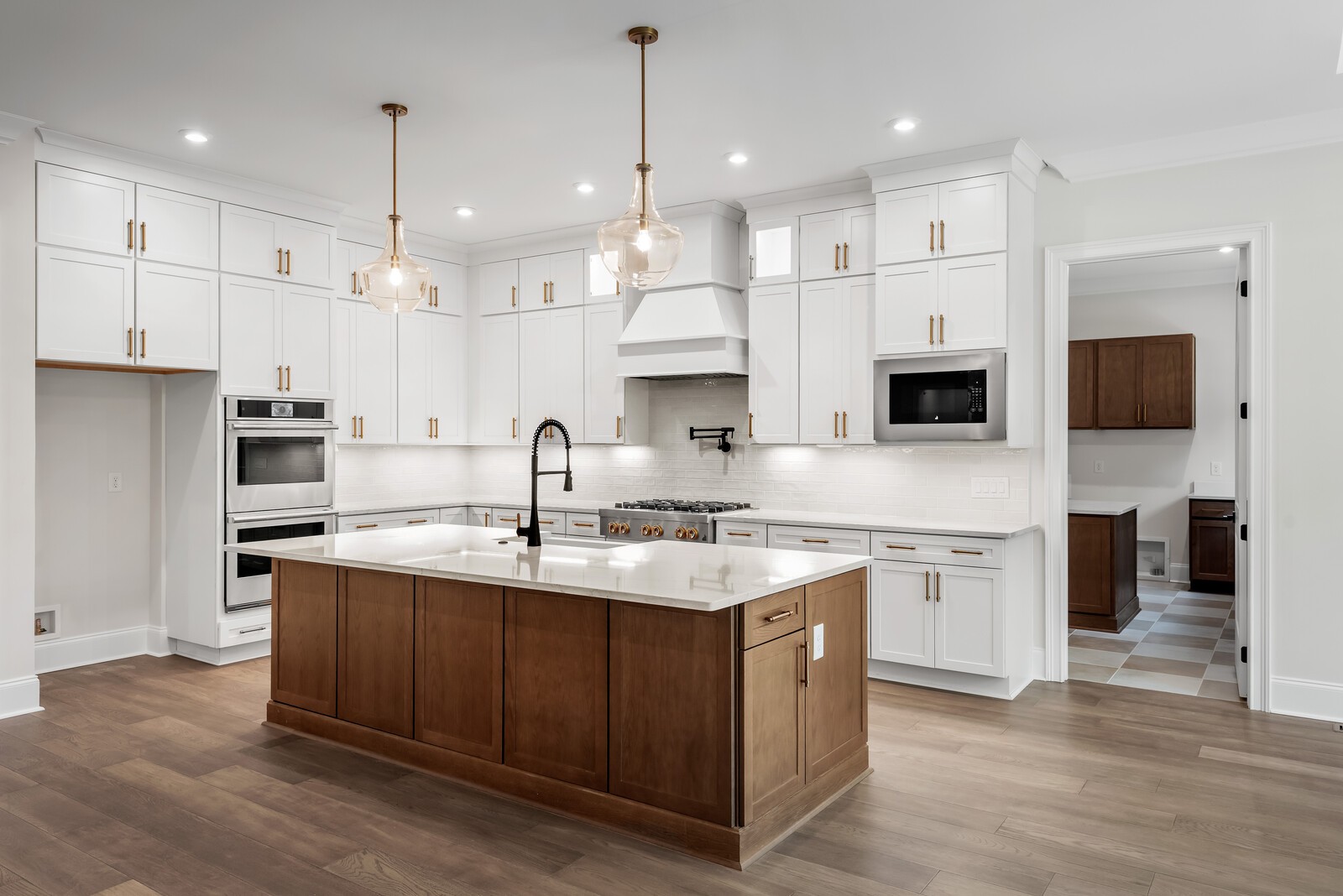 0 Bethesda-Arno Road Thompson's Station, TN 37179 - Photo 25 of 78 a kitchen with stainless steel appliances granite countertop a sink stove a refrigerator and a oven with wooden floor