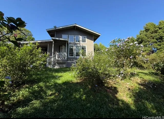 a view of a house with a small yard and plants