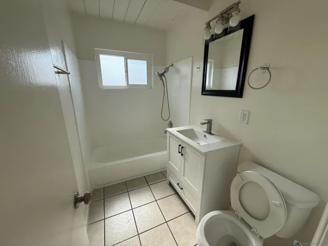 a bathroom with a sink a toilet and mirror