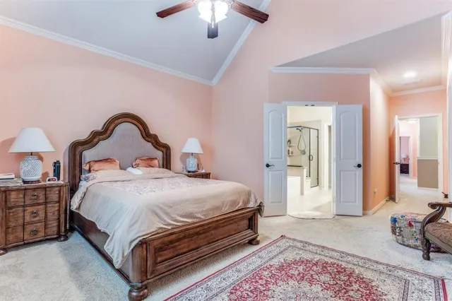 a bedroom with bed and a chandelier