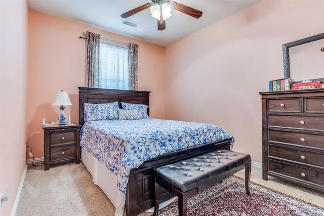 a bedroom with a bed and a dresser