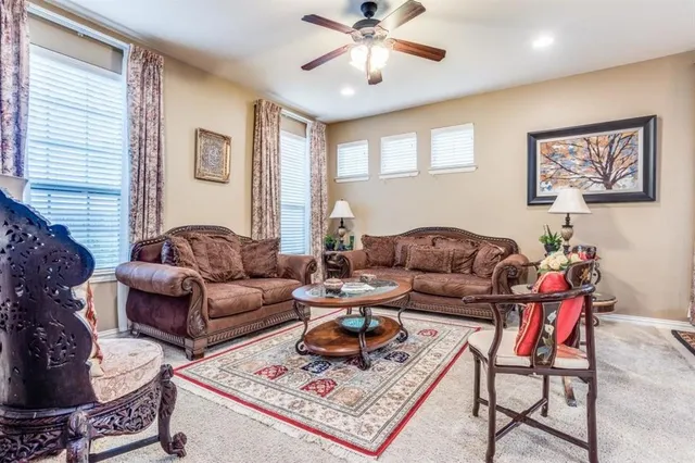 a living room with furniture a rug and a window