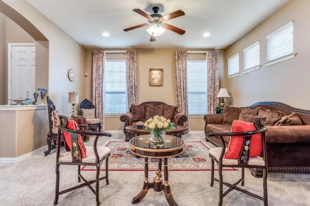 a living room with furniture and a chandelier