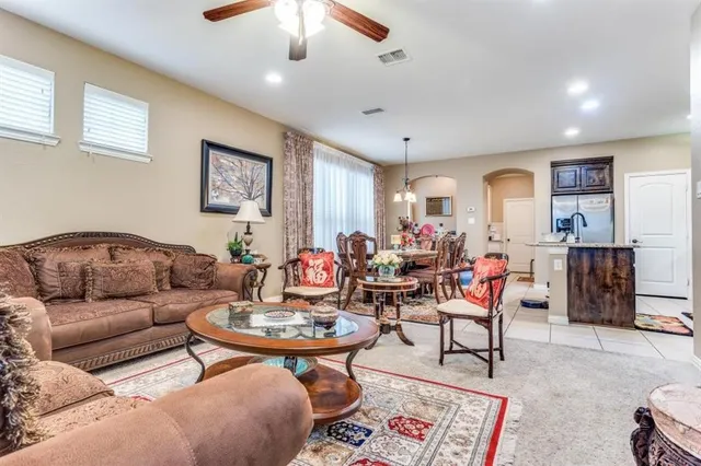 a living room with furniture a rug and a chandelier