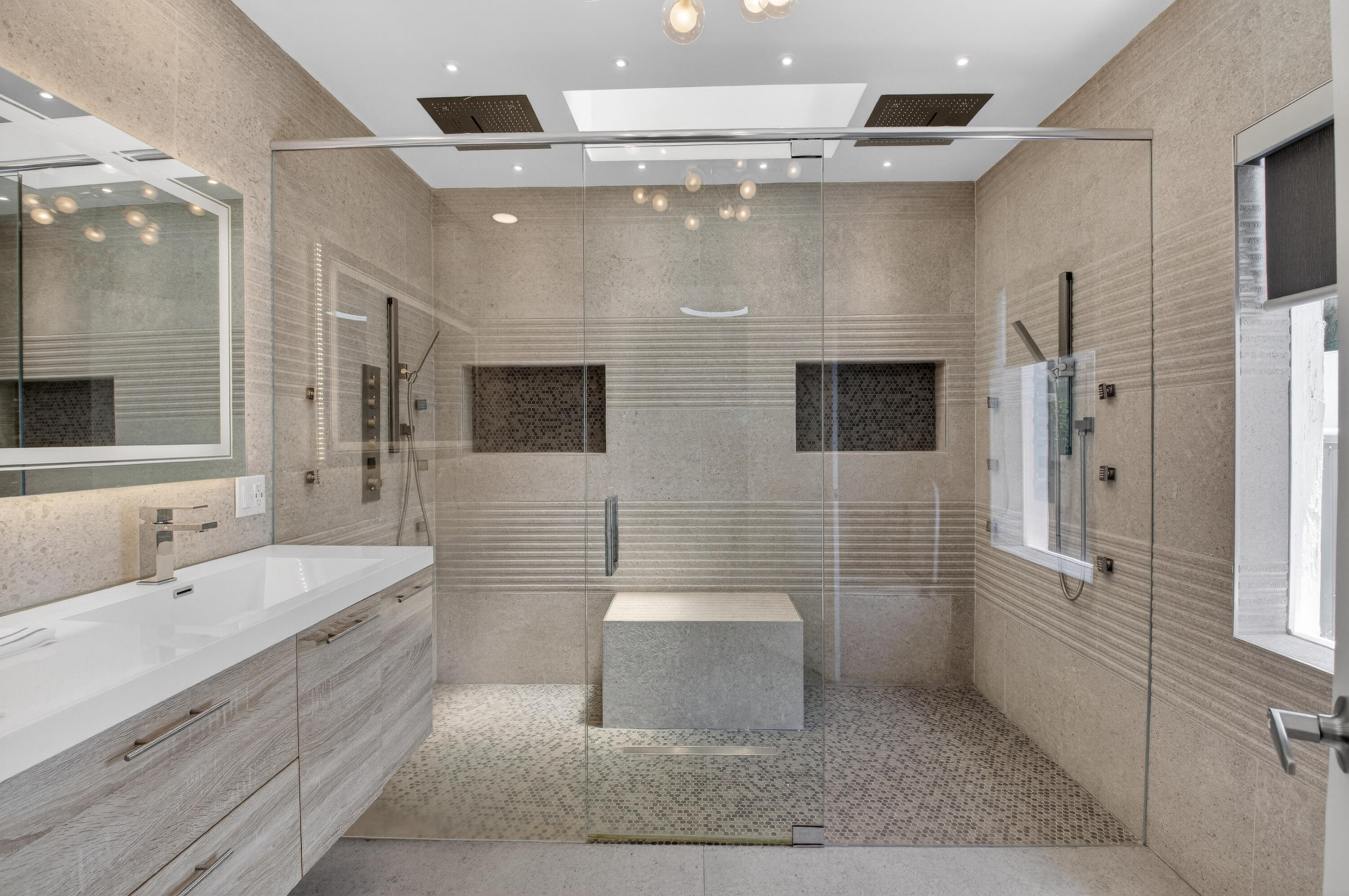 7374 Woodmont Court Boca Raton, FL 33434 - Photo 29 of 95 a spacious bathroom with a double vanity sink a large mirror and a shower