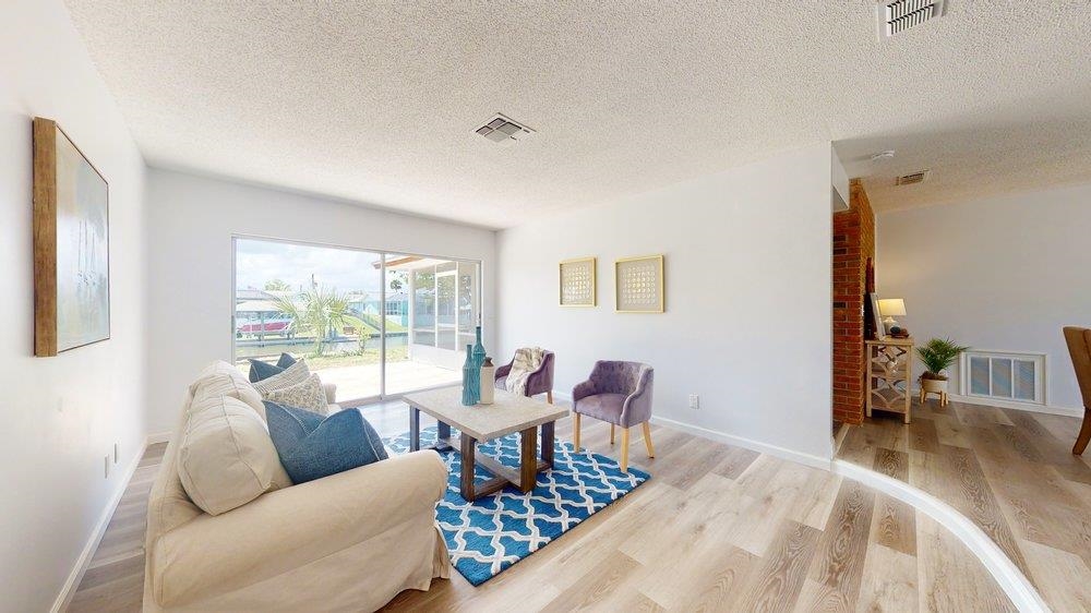 10 Coral Reef Court Palm Coast, FL 32137 - Photo 10 of 44 a living room with furniture and a wooden floor