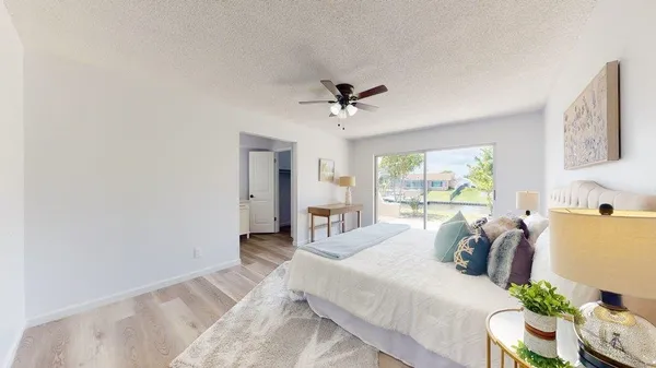 a bedroom with a large bed and a chandelier