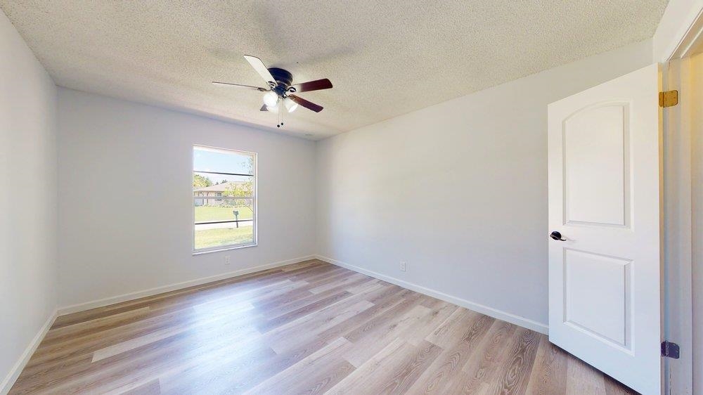 10 Coral Reef Court Palm Coast, FL 32137 - Photo 20 of 44 a view of empty room with wooden floor and fan