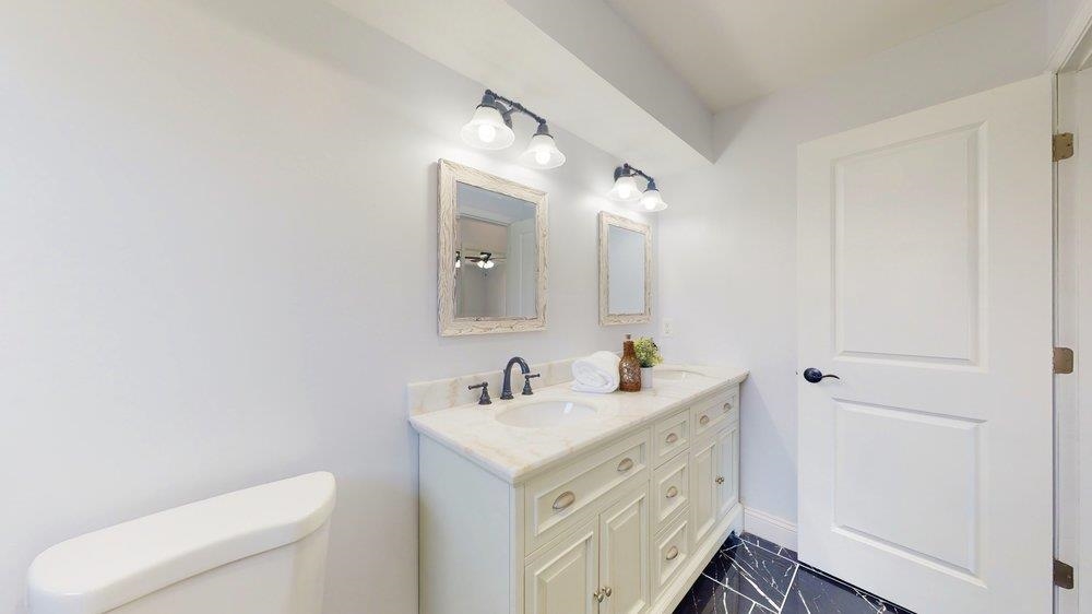 10 Coral Reef Court Palm Coast, FL 32137 - Photo 24 of 44 a spacious bathroom with a toilet sink and mirror