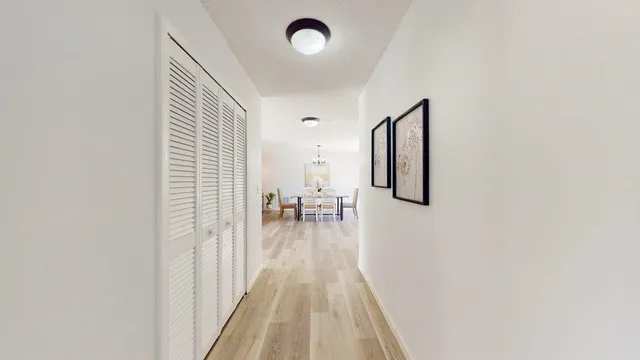 a view of a livingroom with wooden floor and a ceiling fan