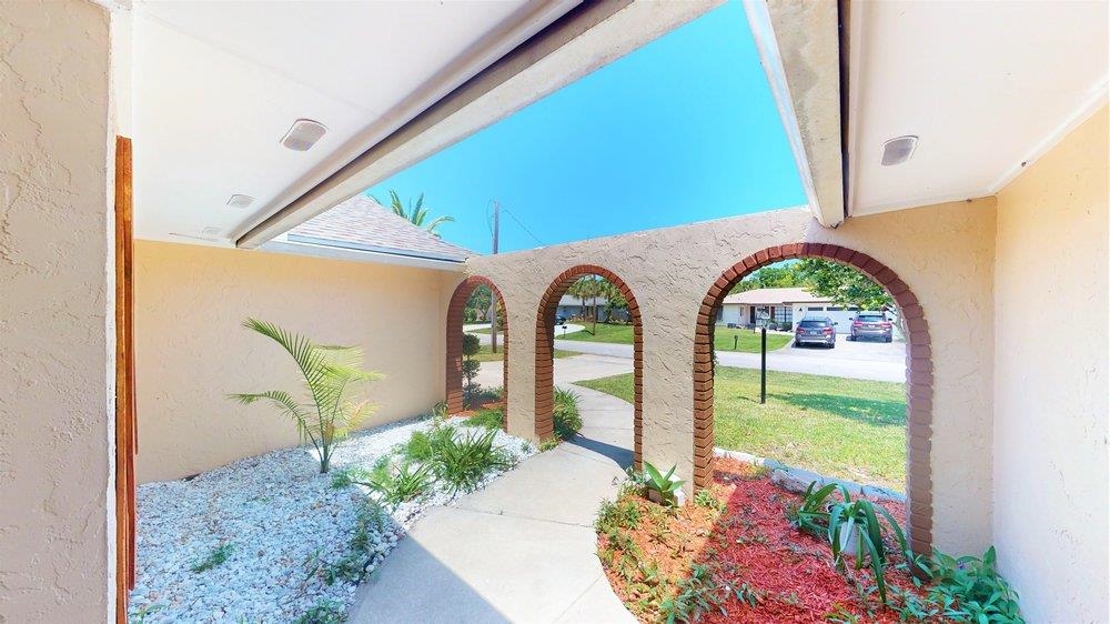 10 Coral Reef Court Palm Coast, FL 32137 - Photo 3 of 44 a front view of a garden