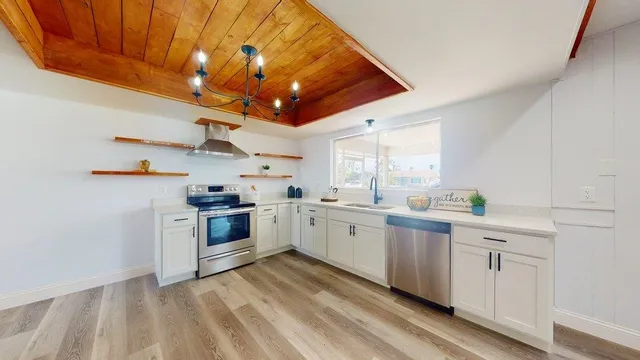 a large living room with stainless steel appliances granite countertop furniture and a fireplace