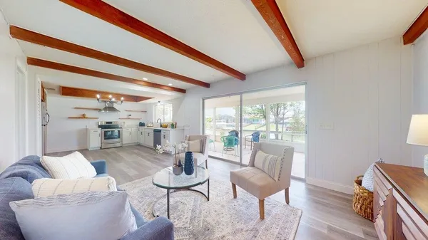 a kitchen with a white cabinets and wooden floor