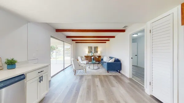 a living room with furniture and a floor to ceiling window