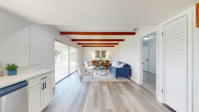 a living room with furniture and a floor to ceiling window
