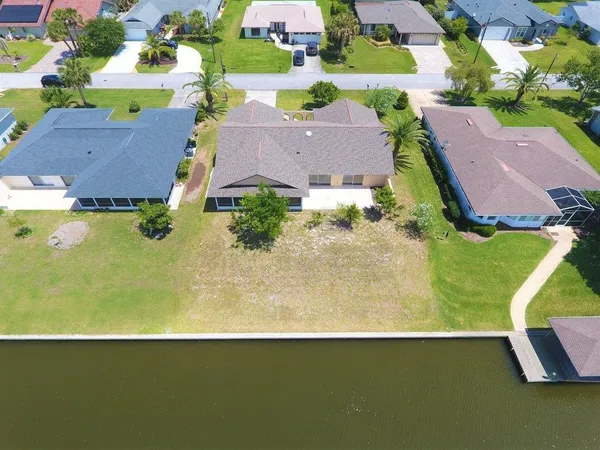 an aerial view of residential houses with outdoor space and swimming pool