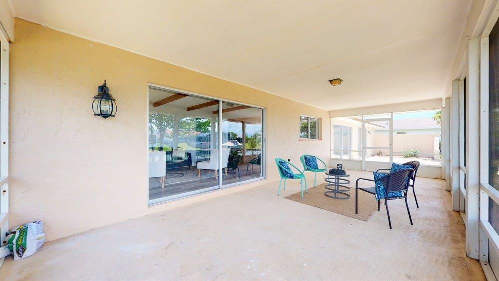 10 Coral Reef Court Palm Coast, FL 32137 - Photo 40 of 44 a dining room with furniture and a floor to ceiling window