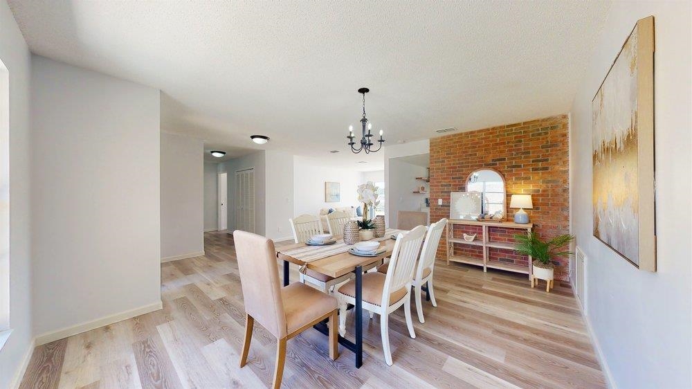 10 Coral Reef Court Palm Coast, FL 32137 - Photo 7 of 44 a view of a dining room with furniture and wooden floor