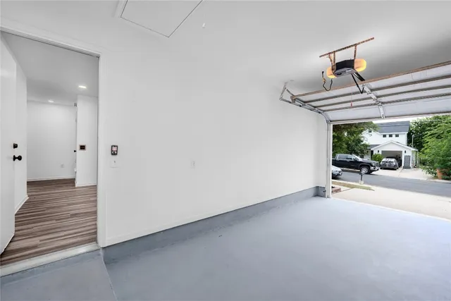 a view of a livingroom with wooden floor and a ceiling fan
