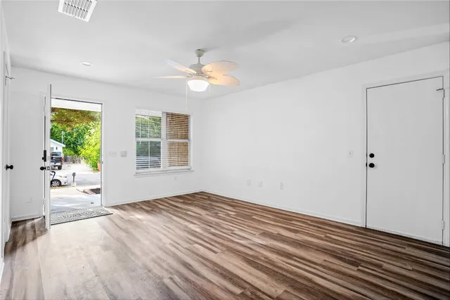 wooden floor in an empty room with a window