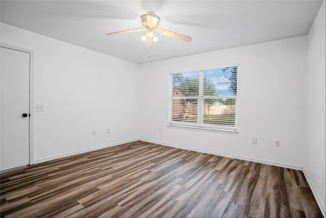 wooden floor in an empty room with a window