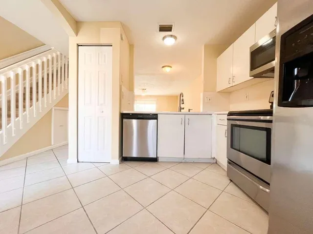 a view of kitchen with cabinets and stainless steel appliances