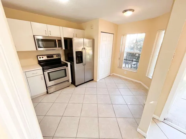 a view of a livingroom with kitchen and furniture
