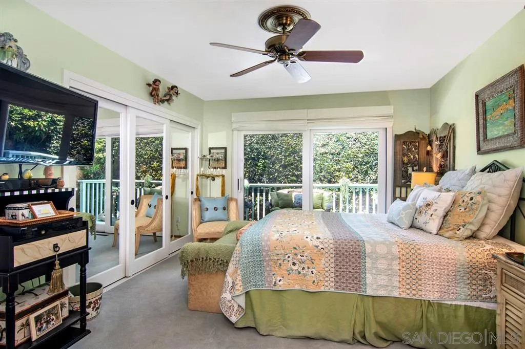 1112 La Jolla Rancho Road La Jolla, CA 92037 - Photo 17 of 25 a bedroom with a bed a flat screen tv and a large window with the outer view
