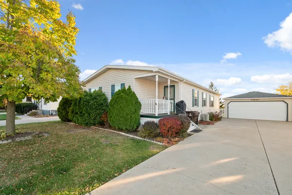 a view of a house with backyard and a tree