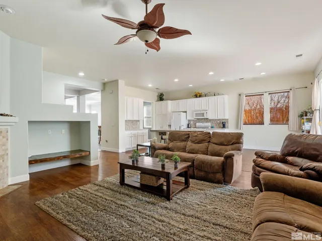 a living room with furniture kitchen view and a table