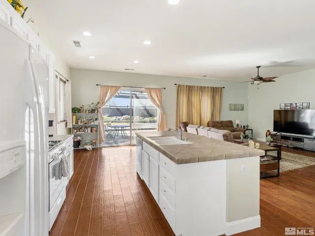 a large white kitchen with a large window