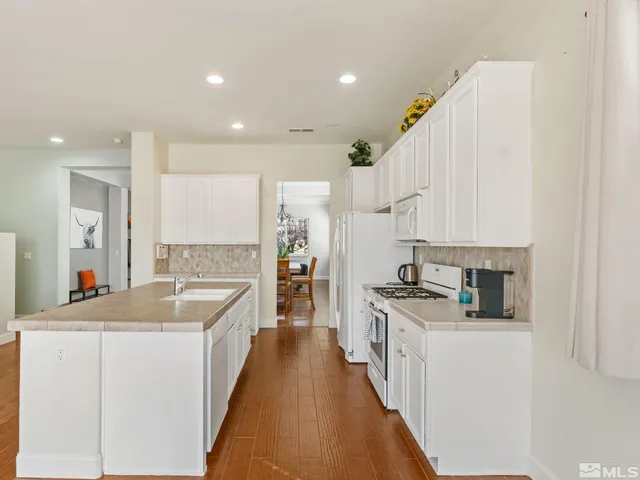 a kitchen with stainless steel appliances granite countertop a sink and cabinets