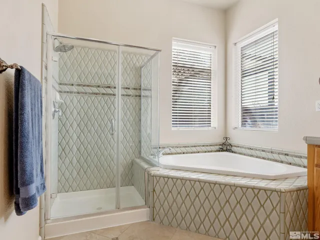 a bathroom with a granite countertop sink double and mirror