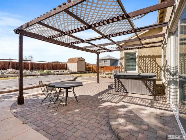 a view of a house with backyard and sitting area