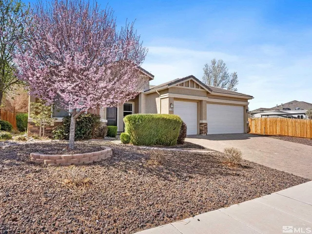 a view of a large house with a yard and large tree
