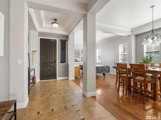 a view of a dining room with furniture and window