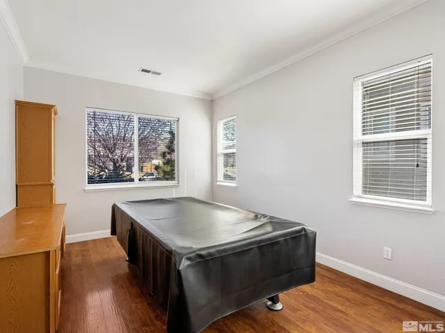 a living room with stainless steel appliances kitchen island hardwood floor and a window