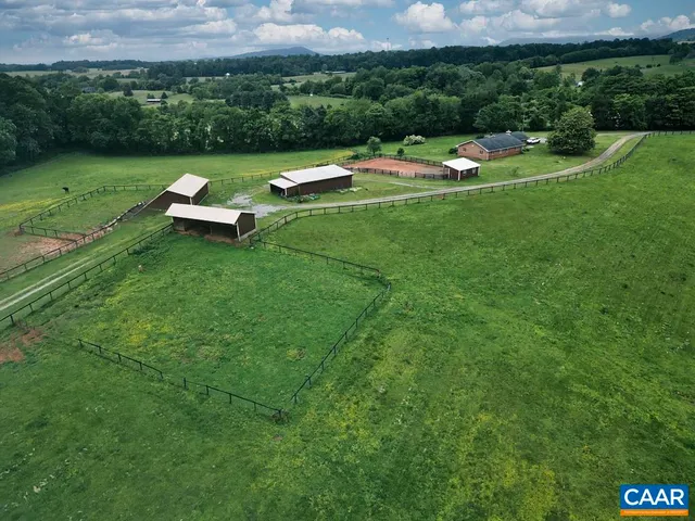 a kitchen with stainless steel appliances granite countertop a refrigerator a stove top oven a sink dishwasher and cabinets with wooden floor