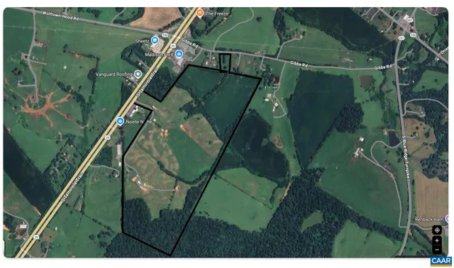 an aerial view of a houses with outdoor space and street view