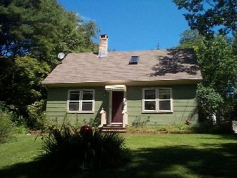 149 Pixley Road Monterey, MA 01230 - Photo 1 of 2 a front view of a house with a garden