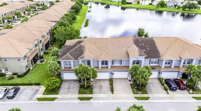 an aerial view of a house with garden space and lake view