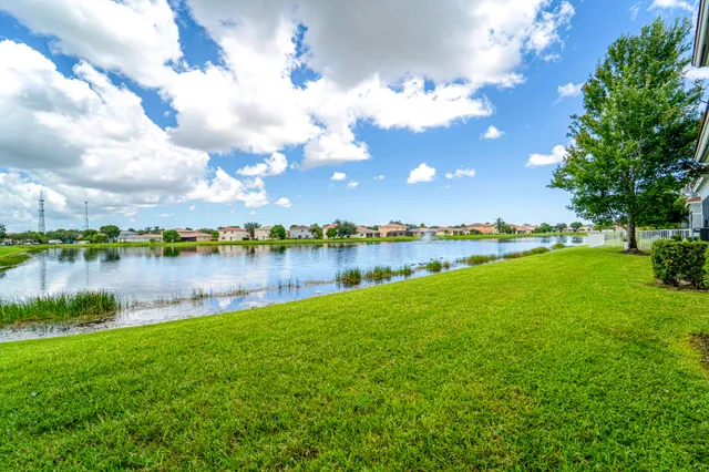 front view of a brick house with a yard