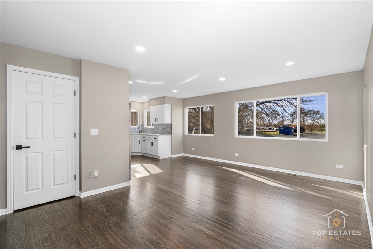 737 Springwood Drive Joliet, IL 60431 - Photo 11 of 31 an empty room with wooden floor and windows