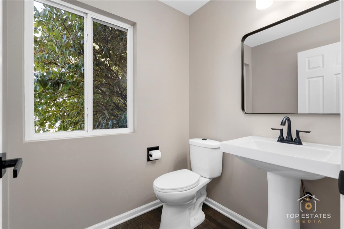 737 Springwood Drive Joliet, IL 60431 - Photo 12 of 31 a bathroom with a toilet sink and mirror