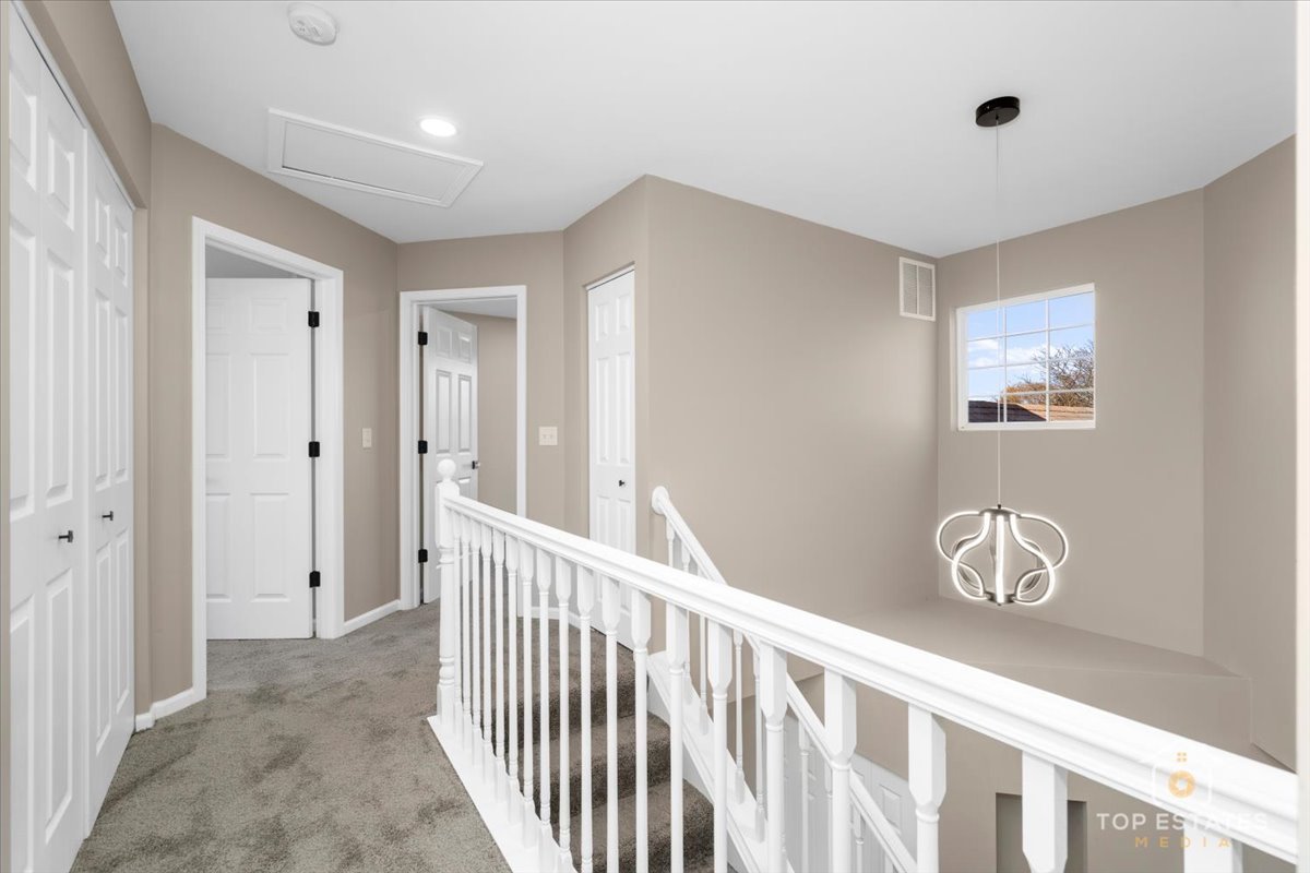 737 Springwood Drive Joliet, IL 60431 - Photo 13 of 31 a view of a hallway to a livingroom with wooden floor